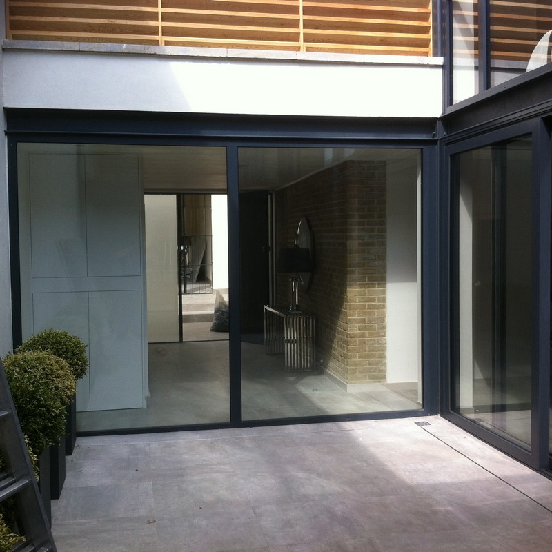 Floor-to-ceiling sliding doors opening to courtyard in Aylesbury